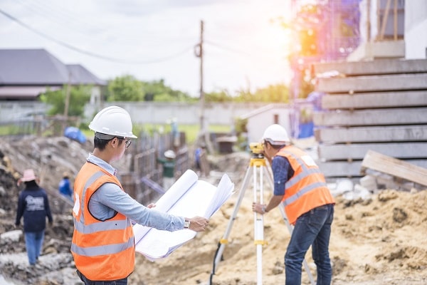 land surveyors working at new home construction