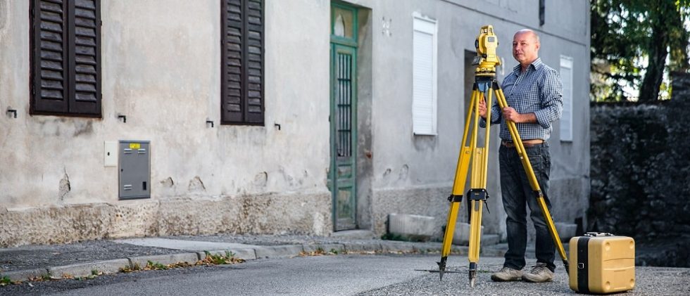 man doing survey in bult up area